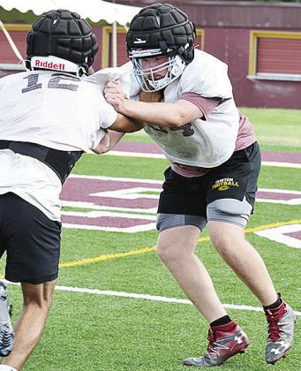 Clinton’s Connor Richardson, right, blocks No. 12 Aaron Ramirez during a practice in the Tornado Bowl. CDN | Sam Goodwyn