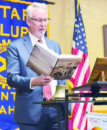 Dr. Randy Kluver reads an excerpt from his recently published “Chào to Main Street” at the book’s launch party last week during the Clinton Rotary Club meeting. CDN | Shiann Dawson