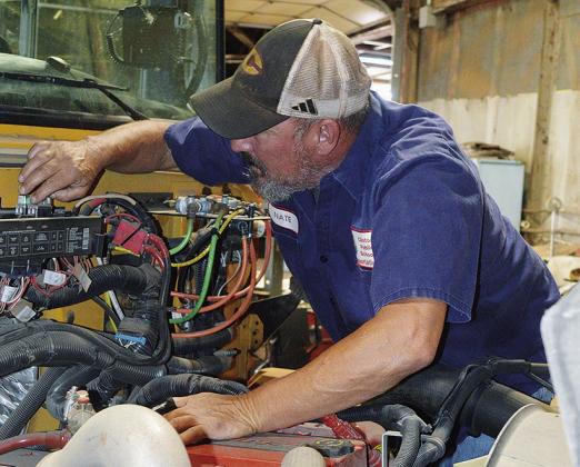 Nate Burnett performs yearly inspections of the school busses at the CPS Bus Barn to ensure they are ready for the new school year. CDN | Christian Jacobsen