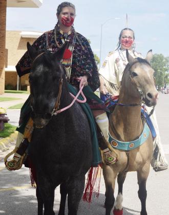 Katie Parker, left, and Cris Hart with face paint ride horses at Friday’s Cinco de Mayo parade. CDN | Michael Maresh