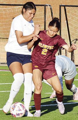 Clinton’s No. 2 Sammy Meraz battles with a Lady Patriot for control of the ball midway through the Lady Reds’ win over the Lady Patriots. CDN | Sam Goodwyn