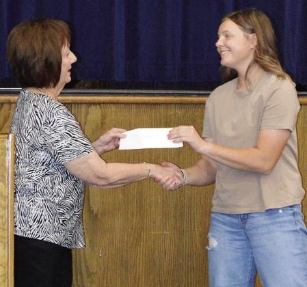 Linda Elston, left, awards the ESA Alpha Nu Scholarship to Malley Baker Wednesday during the Senior Awards Ceremony at the A-B Auditorium. CDN | Christian Jacobsen