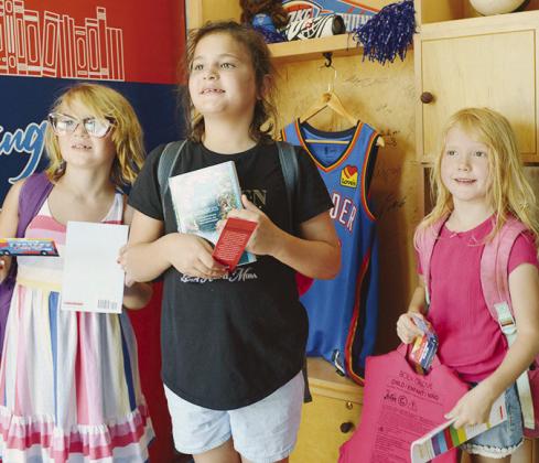 From left, Clara Gregory, Ana Adams, and Emma Armbruster visit the Rolling Thunder Book Bus at the Frisco Center. CDN | Christian Jacobsen
