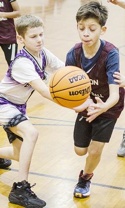 Diego Lara, right, drives through a Hydro defender for the layup during Clinton’s fourth-grade boys’ game at the middle school. CDN |Sam Goodwyn