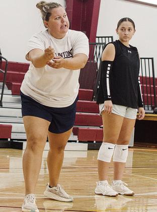 Coach Gabbie Parsons, left, coaches up the team as Aaliyah Lopez watches Thursday in the Clinton High School practice gym. CDN | Sam Goodwyn