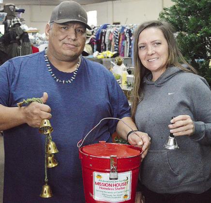 Chuck Whitetail, left, and Clinton Mission House Director Jennifer Lee dust off the Mission House donation bucket in time for bell ringing. CDN | Micah Ashcraft