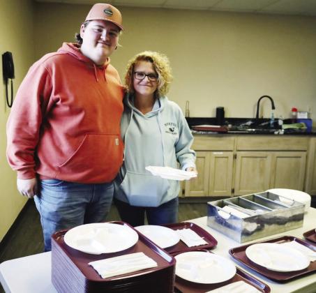 Hunter Powell, left, and Hannah Ingel prepare serving trays for guests at the annual Cornerstone Church Thanksgiving Feed.