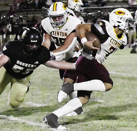 Clinton’s Easten Powell carries the ball as No. 75 Eli Anderson provides a block for him during the Red Tornadoes’ win over Woodward. CDN | John Kinsey