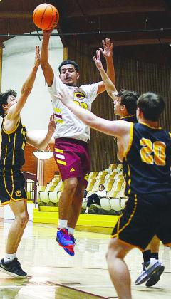 Cruz Rios flies into the air to pass the ball during Clinton’s JV game against Canute’s varsity team. CDN | Sam Goodwyn