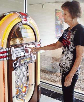Oklahoma Rt. 66 Museum Director Pat Smith selects a tune from the lobby jukebox. CDN | Micah Ashcraft
