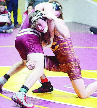 Clinton’s Landon Wilson, right, attempts a fireman’s carry of his opponent during the District Duals held at the Tornado Dome. CDN | Sam Goodwyn