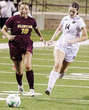 Clinton’s Leila Pete, left, outraces the Woodward defender during the Lady Reds’ win Thursday at home. CDN | Sam Goodwyn