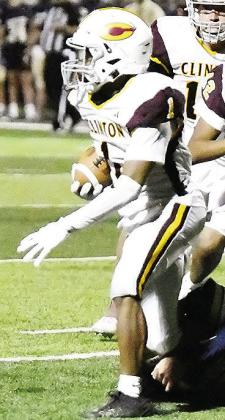 Clinton’s Derren Hester fights through an ankle tackle during the Red Tornadoes’ road game at Kingfisher. CDN |John Kinsey