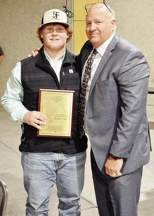 Brayden Fuller, left, poses with Coach John Higbee after being awarded the Fred Friedrich Leadership Award at the annual football banquet in the Frisco Center to end the season. CDN | Sam Goodwyn