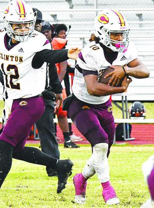Clinton’s No. 10 Darius RomanNose takes the handoff from quarterback Sutton Hernandez during the Red Tornadoes’ regular season finale win over the Douglass Trojans in Oklahoma City. CDN | John Kinsey