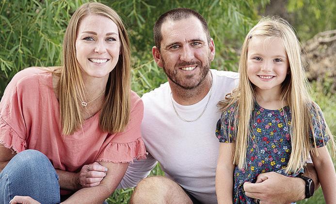 New Clinton Defensive Coordinator Skylar Watson, center, smiles with his wife Jannie, left, and daughter Journey, right. CDN | Courtesy photo