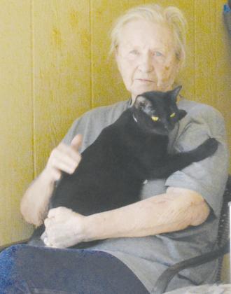 Sue Morries was excited for the photo and went to grab her cat Dalila to pose at Forrest Lane in Clinton. CDN | Christian Jacobsen