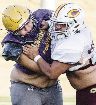 Clinton’s Roderick Barker, right, blocks an Anadarko defender during the Red Tornadoes’ scrimmage in the Tornado Bowl. CDN | Sam Goodwyn