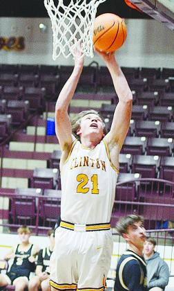 Senior Ayden Crumley lays the ball into the hoop during Clinton’s home game against Woodward. CDN | Sam Goodwyn