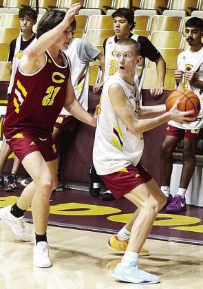 Clinton’s Ayden Crumley, left, defends against Ryder Adams during a Reds’ practice in the Tornado Dome. CDN | Sam Goodwyn