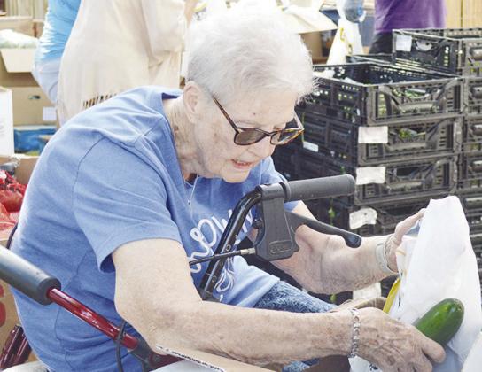 Alice Wahling helps put fresh cucumbers into bags after being delivered to the Mission House food pantry. CDN | Micah Ashcraft