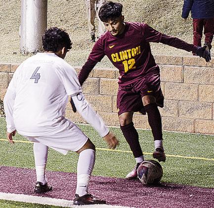 No. 12 Austin Reynaga keeps the ball to himself as he tries to find a way around the Southeast defender during Clinton’s home game Thursday against the Spartans. CDN | Sam Goodwyn