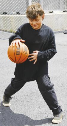 Bradly Garcia shows off his dribbling skills with a basketball at Southwest Elementary. CDN | Christian Jacobsen