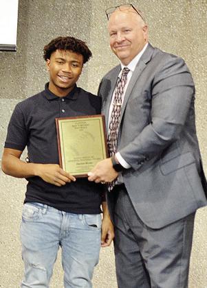 Derren Hester, left, smiles with Coach John Higbee after being named the Randy Kiesau No. 22 Memorial Award for the team this season after his play in all phases of the game. CDN | Sam Goodwyn