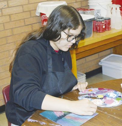 Analise Sevenstar adds cornstarch to her paint to thicken up the consistency at Clinton High School. CDN | Christian Jacobsen