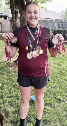 Clinton’s Kendall Serfoss shows off her scores of track and field medals. CDN |Courtesy Photo