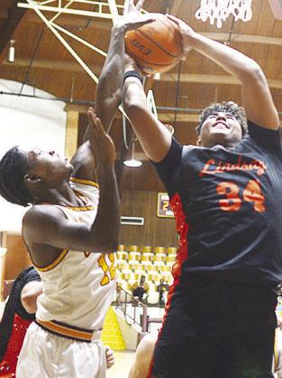 Clinton’s Atticus Thompson tries to block a shot during the Reds’ homeopener against the Lindsay Leopards in the Tornado Dome. CDN | Sam Goodwyn