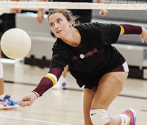 Clinton’s Lillian Heerwald reaches low for the ball during warm-ups prior to the Lady Reds’ first game in the Best of the West Tournament Friday in the new middle school gym. CDN | Sam Goodwyn