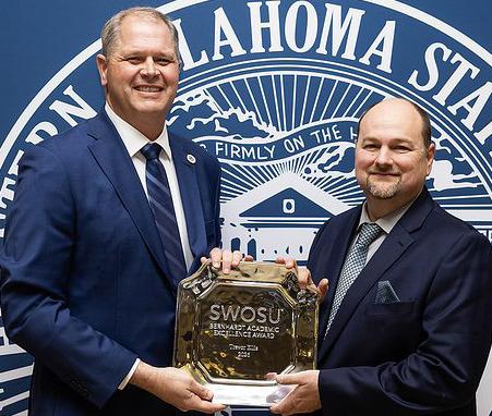 Interim President Dr. Joel Kendall, left, presents the 2026 Bernhardt Academic Excellence Award to Dr. Trevor Ellis at Southwestern Oklahoma State University. CDN | Courtesy photo