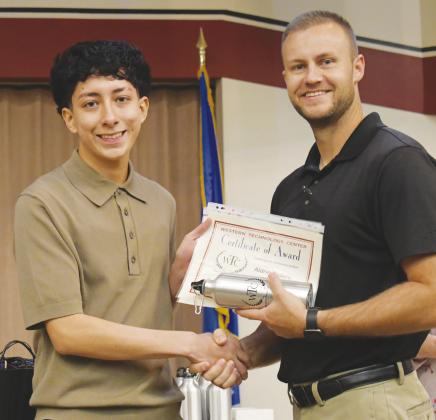 Clinton High School student Aldrin Rodelo is awarded Outstanding Attitude of the Year in business technology from WTC Director of Student Services Zane Trammell. CDN | Courtesy photo