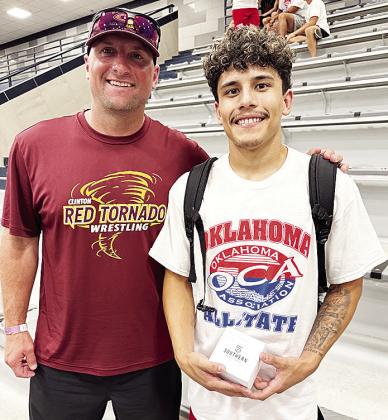 Clinton’s Tristan Cardenas, right, smiles with Clinton wrestling coach Rhett Blundell after competing in the All-State Wrestling Match Thursday at Edmond North High School. CDN | Courtesy photo