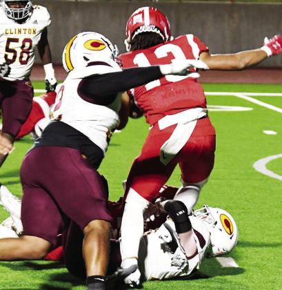 No. 32 Malachi Lorne and Cooper Sulley combine to take down the Cache ball carrier during the loss to the Bulldogs Friday. Montiel Crane comes to help get him down.