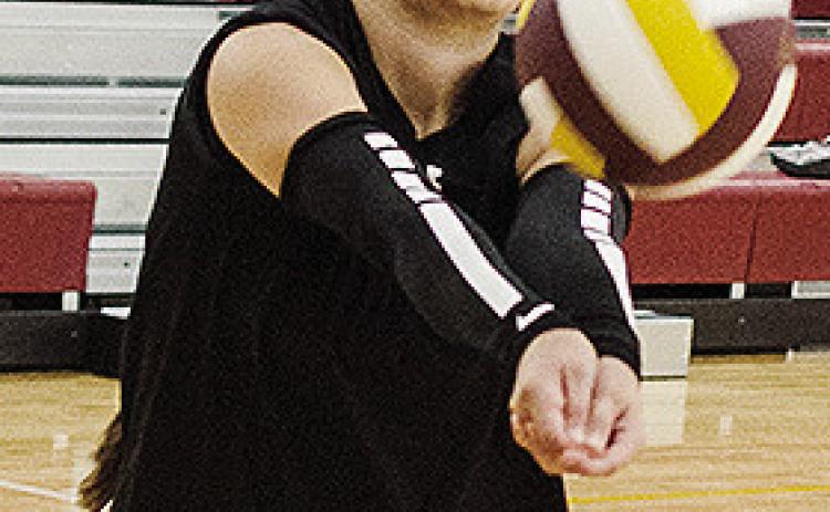 Clinton’s Aaliyah Lopez returns the ball back over the net during practice in the practice gym. CDN | Sam Goodwyn