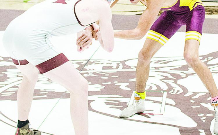 Clinton’s Vicente Gutierrez, right, grapples with his opponent during the District Duals at Elk City. CDN | Sam Goodwyn