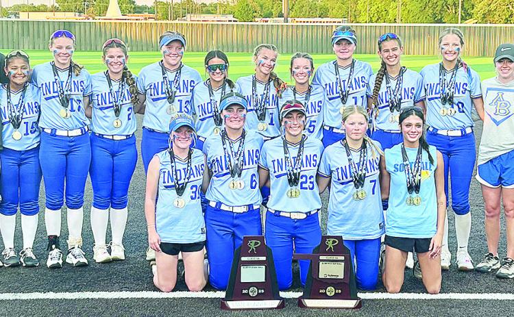 Despite the outcome, the Arapaho-Butler Lady Indians’ softball team are all smiles as they pose with the Class 3A State Runnerup and the Class 3A Academic State Championship trophies after the title game against Caddo Monday at the FireLake Ball Fields