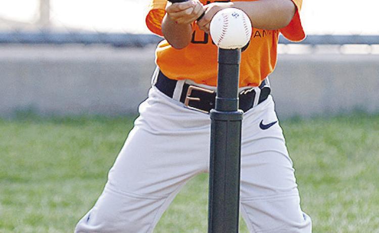 Daniel Martinez focuses on the ball as he prepares to hit it during his Noon Lions T-Ball game Tuesday at Schumacher Fields at Acme Brick Park. CDN | Sam Goodwyn