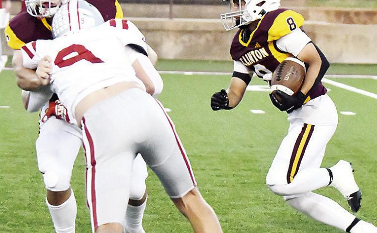 Clinton’s Benton Bridgeman, left, blocks Weatherford’s Kalen Clift, as No. 8 Jaden Potter hustles through with the ball during the Red Tornadoes’ win in the “Custer County Conflict” Friday in the Tornado Bowl. CDN | John Kinsey