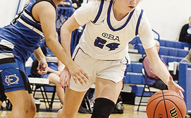 Lady Crusaders’ Brylie Driskill controls the ball against the defender as she drives to the basket in CBA’s win over O-E CDN | Sam Goodwyn