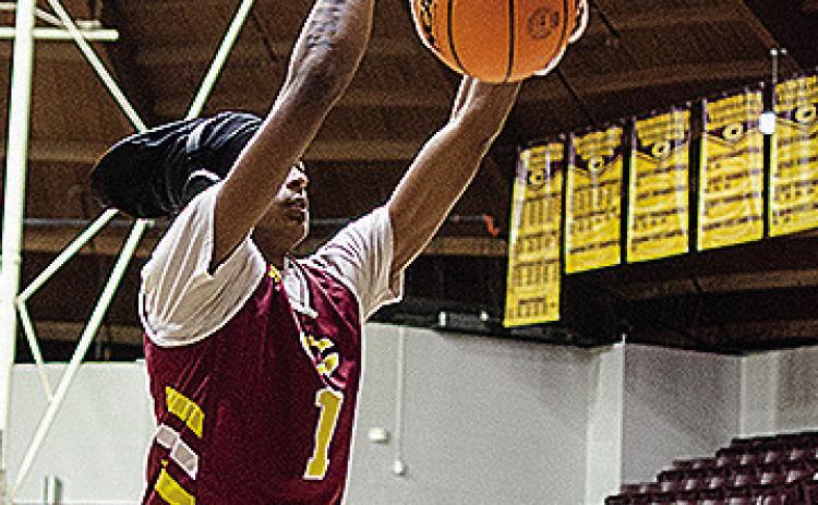 Clinton’s DJ Lister dunks the ball as he warms up for practice in the Tornado Dome. CDN | Sam Goodwyn