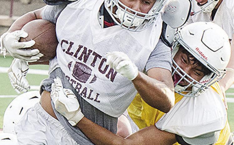 Clinton’s Jesus Gutierrez, left, runs through CJ Begay’s tackle during Monday’s football practice at the Tornado Bowl. CDN | Sam Goodwyn