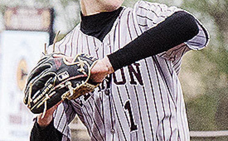 Clinton’s Jeter King goes into his wind up Friday as he prepares to pitch during the Reds’ home game against Kingfisher. CDN | Sam Goodwyn