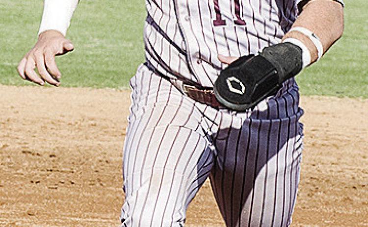 Clinton’s Eli Anderson hustles to third base during the Reds’ home game against El Reno. CDN | Sam Goodwyn