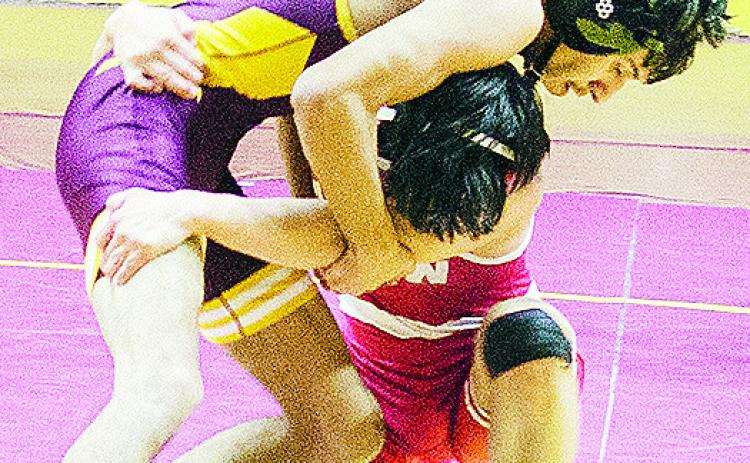 Clinton’s Brandon Rodriquez-Escalante, top, grapples with the Hinton wrestler during the Reds’ season-opening match Thursday in the Tornado Dome. CDN | Sam Goodwyn