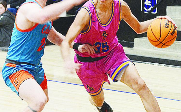 No. 35 D’Shawn Washee drives by a Calumet defender during Arapaho-Butler’s home game against the Chieftans. CDN | Sam Goodwyn
