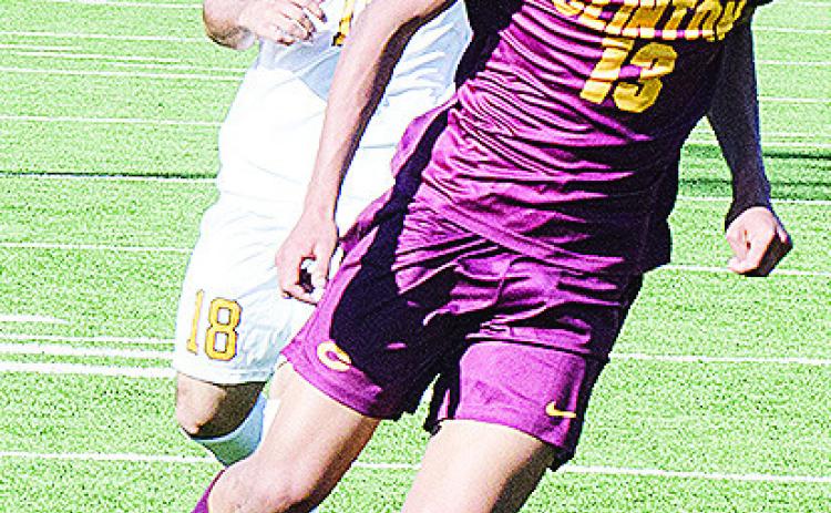 Clinton’s Titan Malone beats the Classen defender to the ball during the Reds’ home game against the Comets. CDN | Sam Goodwyn
