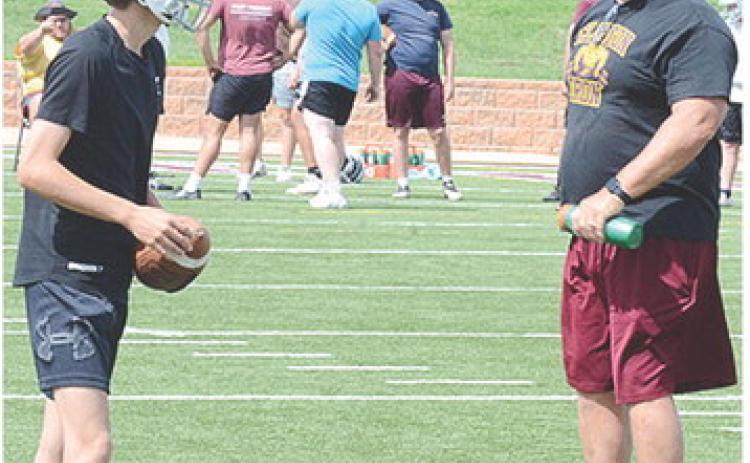 Snider Dowdell, left, gets coached up by Head Coach John Higbee during practice. CDN | Sam Goodwyn